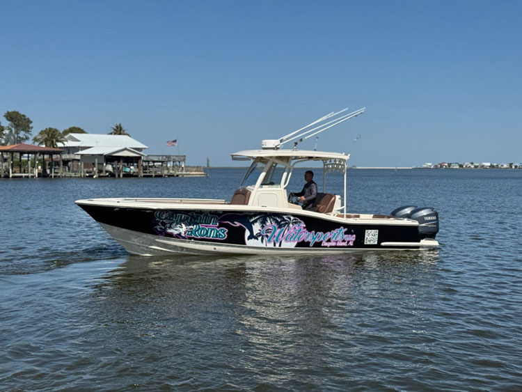 Captain Ron’s Watersports boat cruising on calm bay water