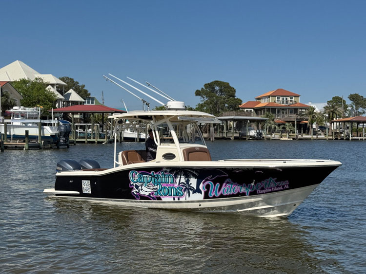Captain Ron’s Watersports boat floating at the dock on calm water